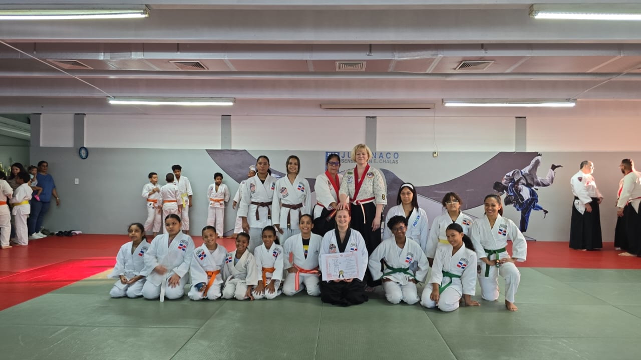Women's jujutsu group photo with certificates